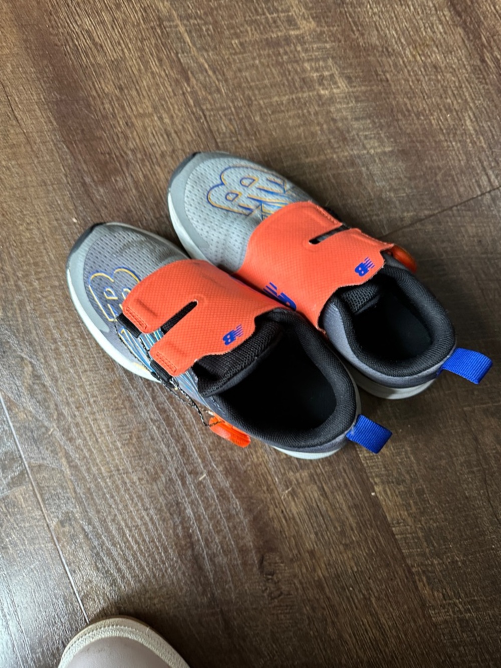 New Balance Kids Orange and Gray Hook-and-Loop Sneakers with Blue Pull Tabs